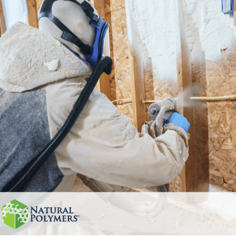 a man in safety gear using spray fill insulation