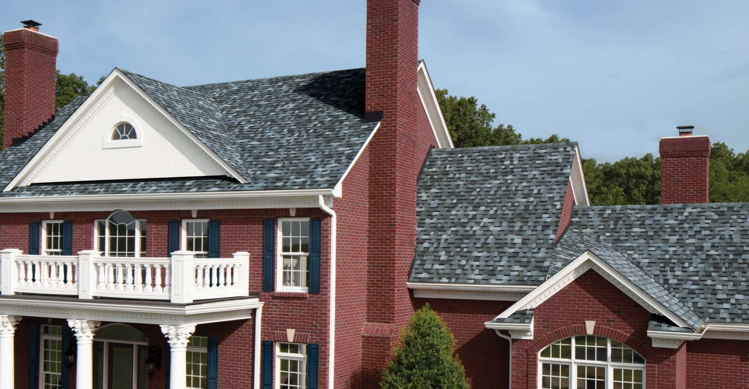 A brick house with a Pacific Wave roof