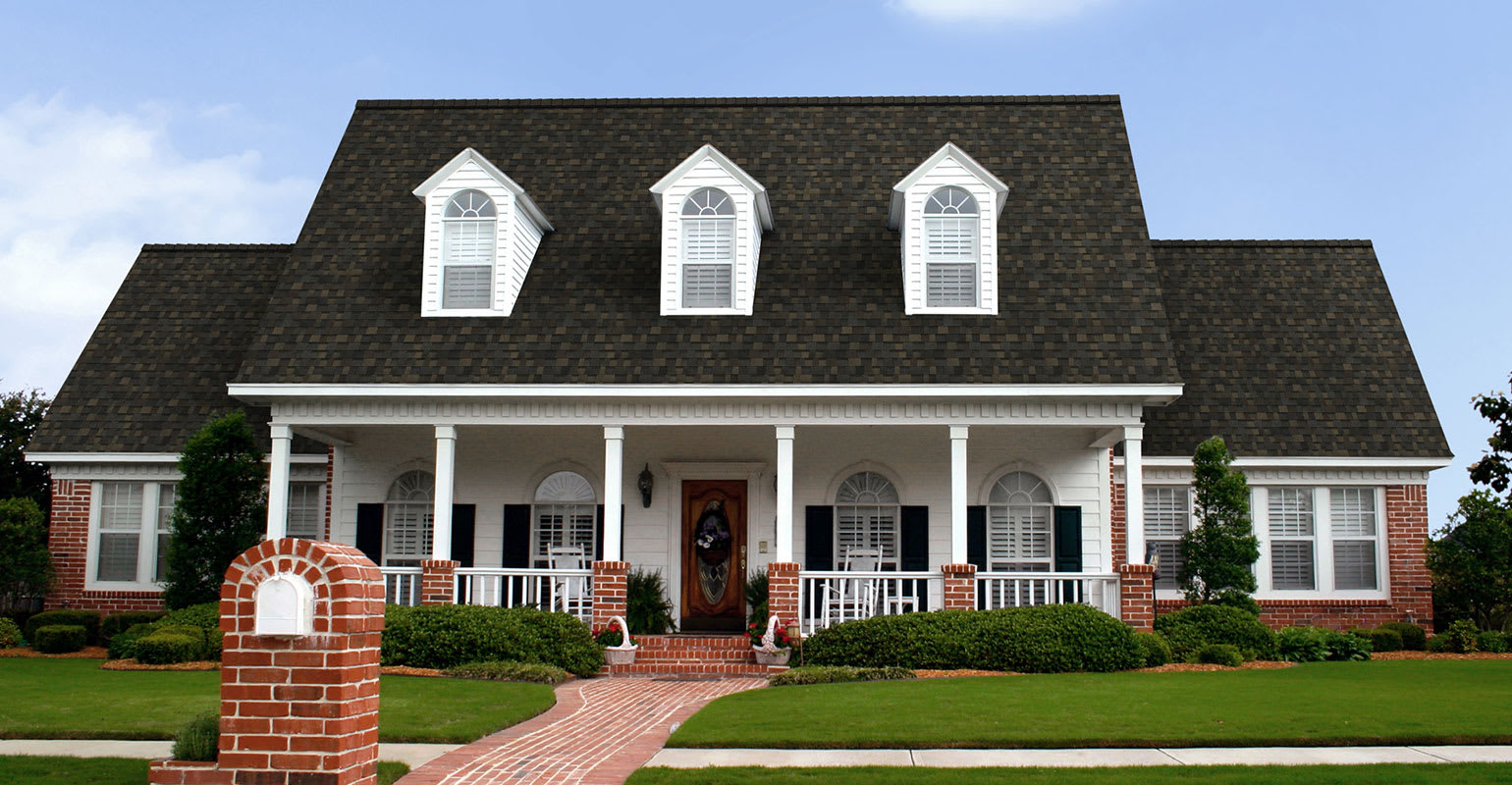 White and brick house with a roof using Black Sable TruDefinition® Duration shingles