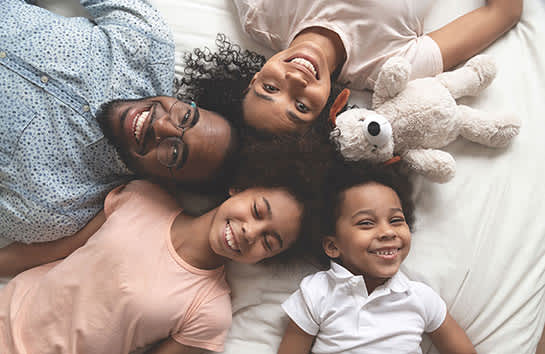 family laying down looking up at camera