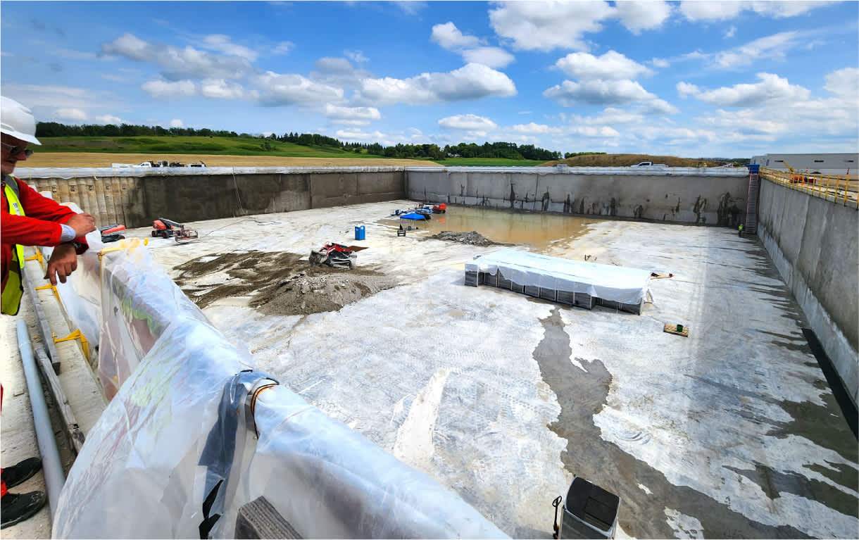Worker staring at an impoundment pit