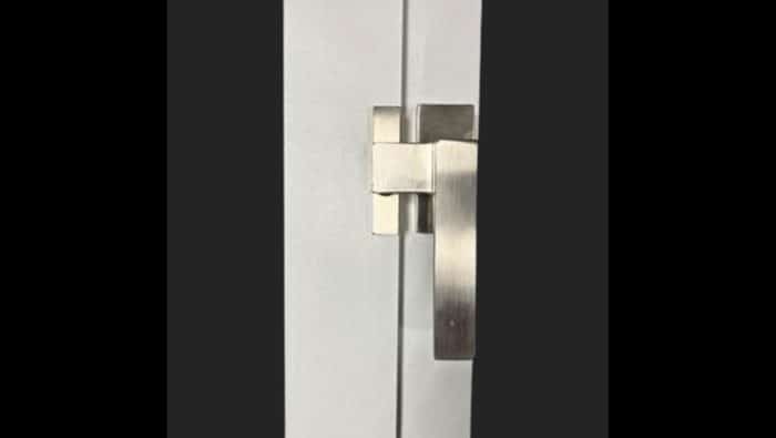 Close-up view of stainless steel brushed lever-style door handle.
