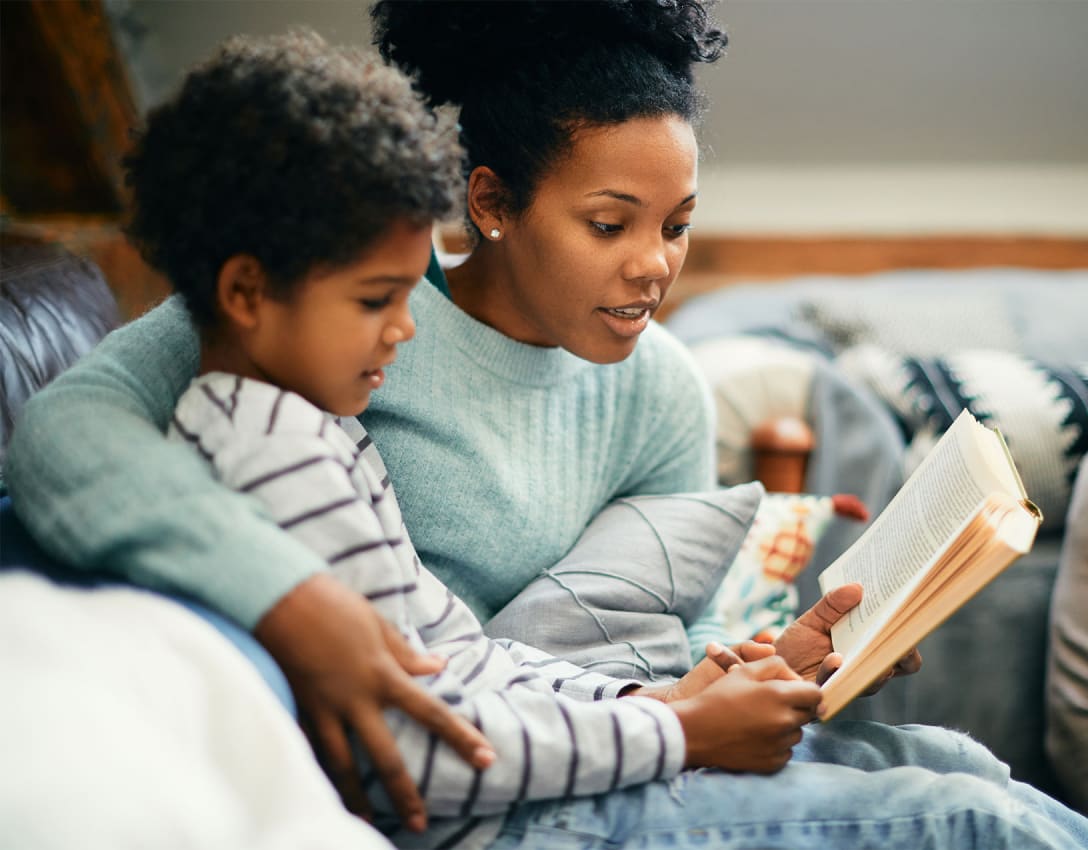 Woman reading a book with a child