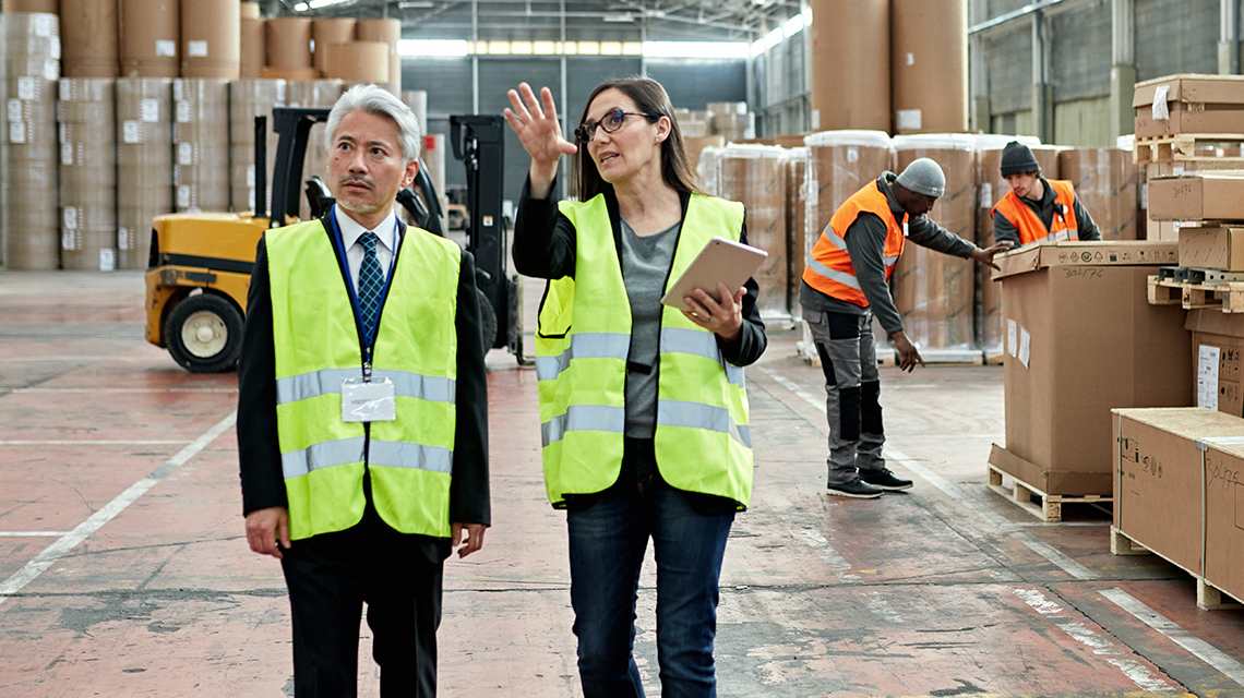 Photo of employees at a warehouse going through inventory.