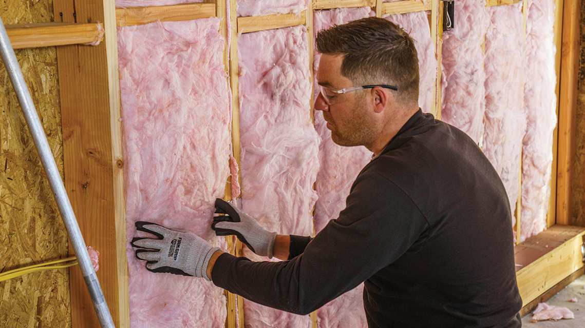 Photo of our Owens Corning fiberglass insulation being installed.