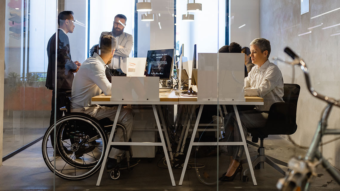 Photo of employees in a conference room.