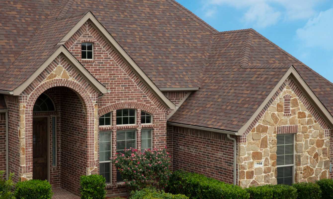 Home with red brick and stone exterior in various patterns and textures
