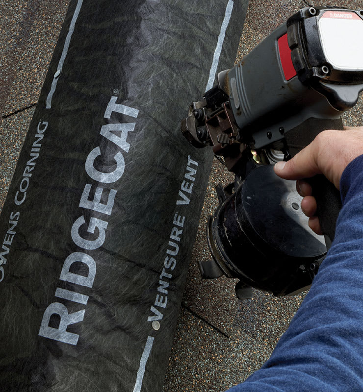 Closeup image of a contractor installing RidgeCat® on a roof