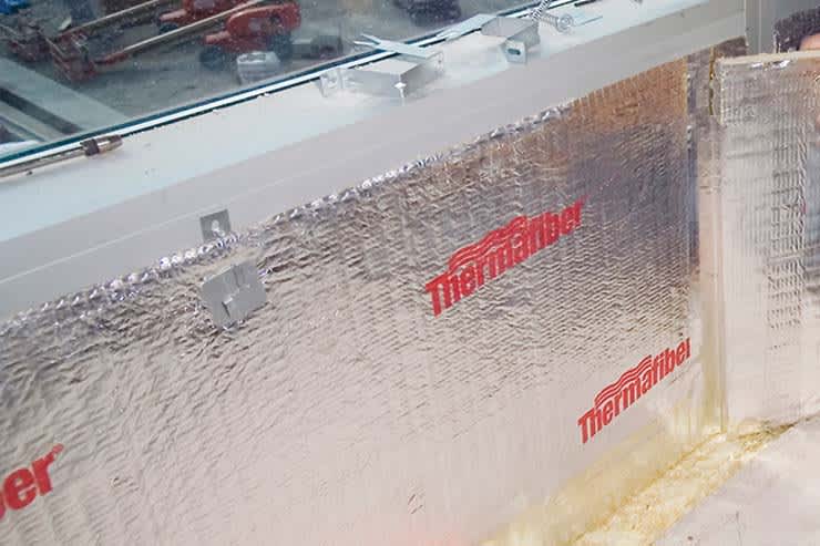 Thermafiber aluminum foil installed on a section of wall