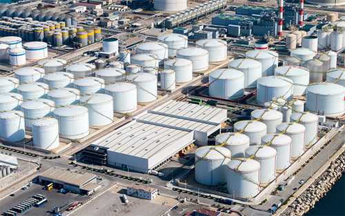 Factory exterior with many holding tanks. 