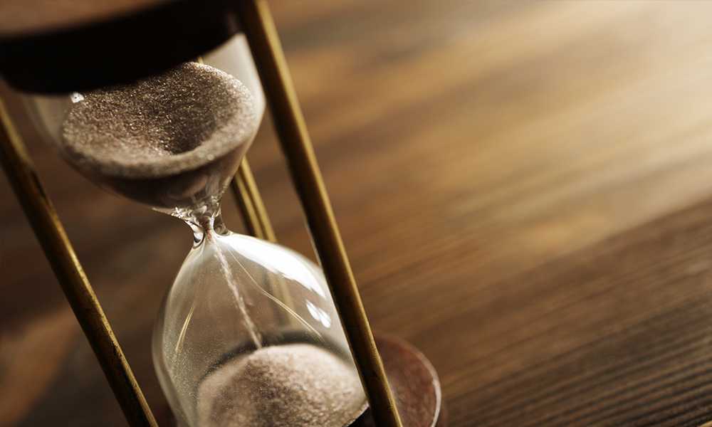 Hourglass on a wooden table