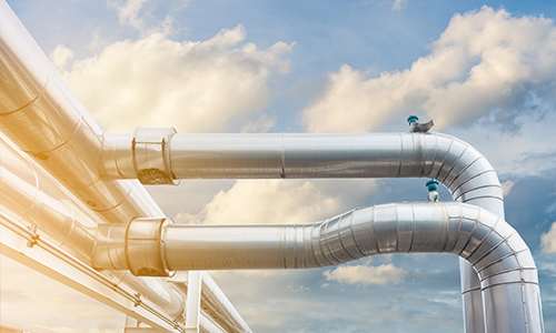 Metal jacketed pipes in sunlight