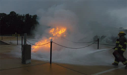 Fireman extinguishing a LNG pool fire