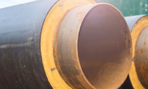 Cross section of piping with organic foam insulation with signs of deterioration.