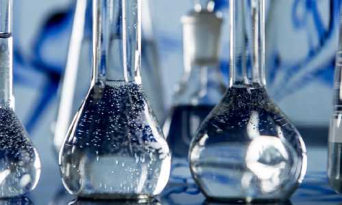 Glass chemistry beakers holding a clear liquid