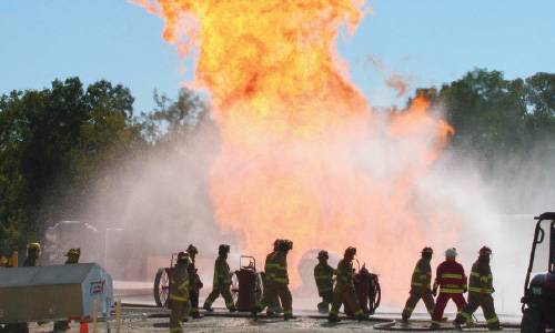 Firemen at the site of a LNG site fire