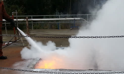 Fireman putting out a fire with a hose