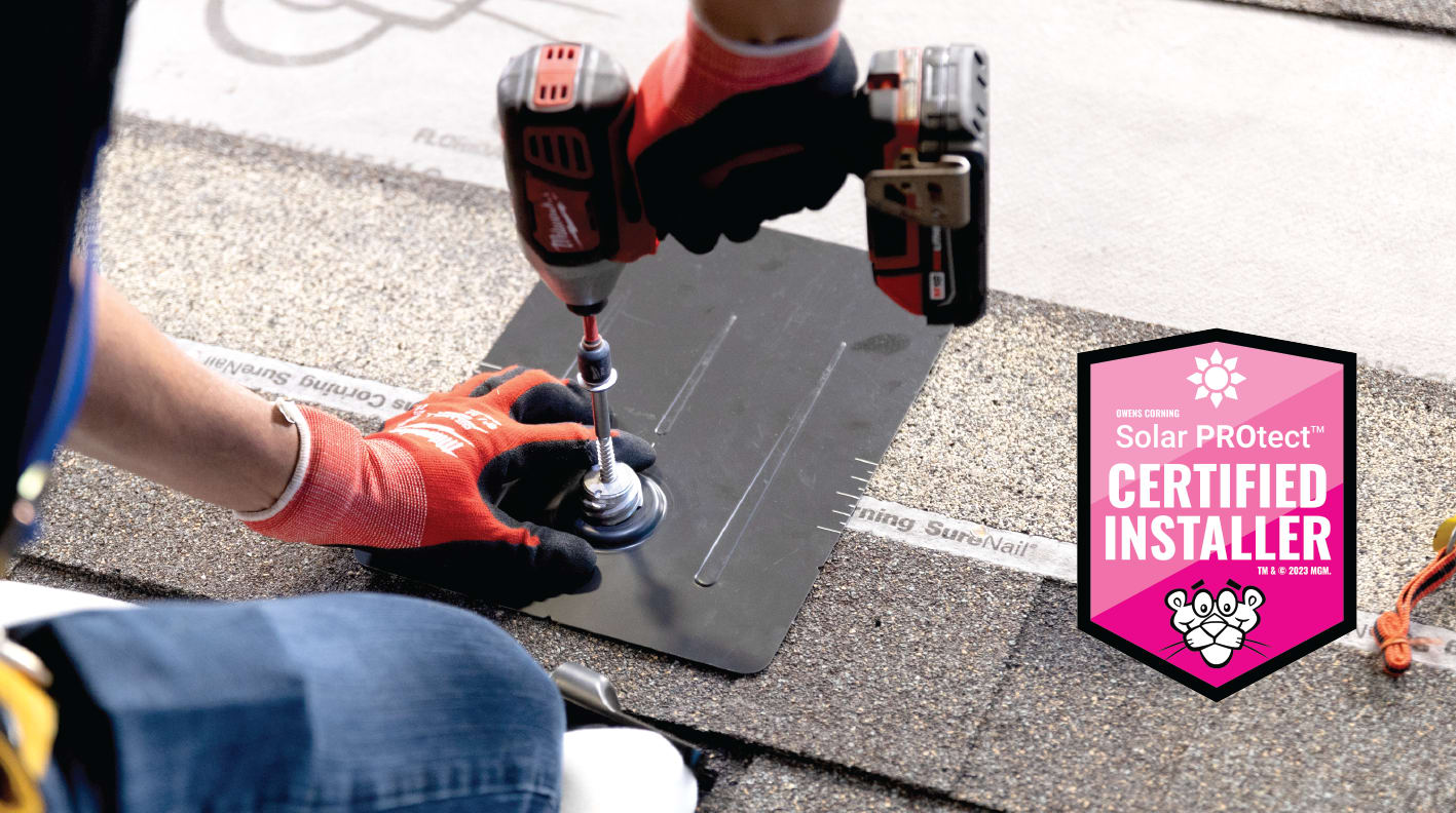 Contractor drilling solar panel mount onto Owens Corning roof with the Solar PROtect Certified Installer badge