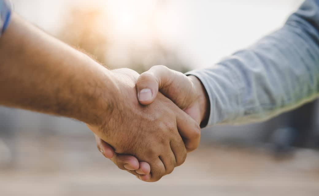 Two hands embracing in a handshake