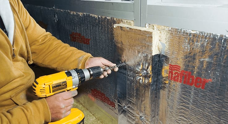 person installing Thermafiber® Impasse®