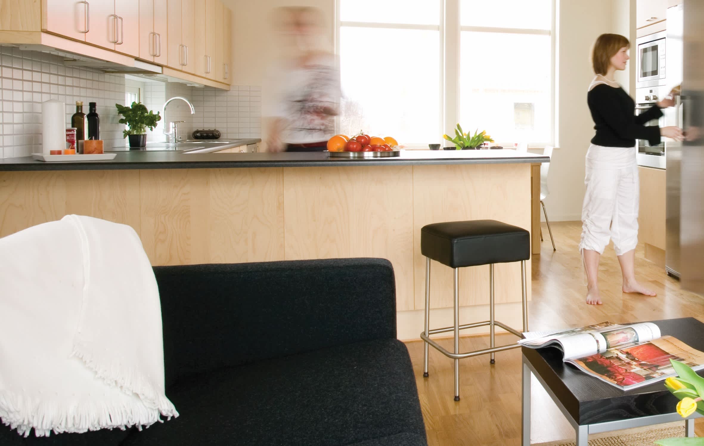 a man and a woman standing in a kitchen