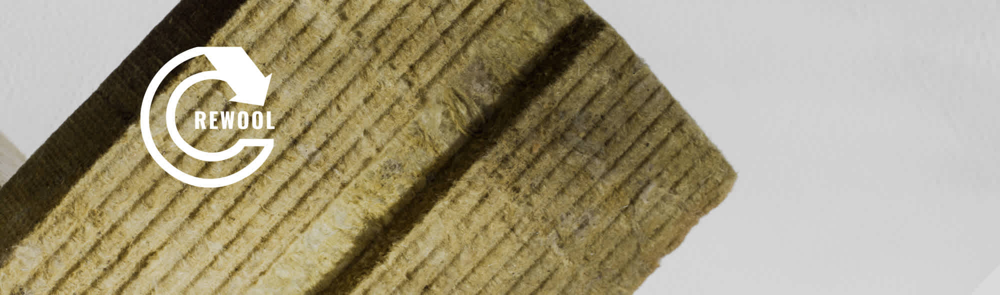 a piece of stone wool with the Rewool logo 