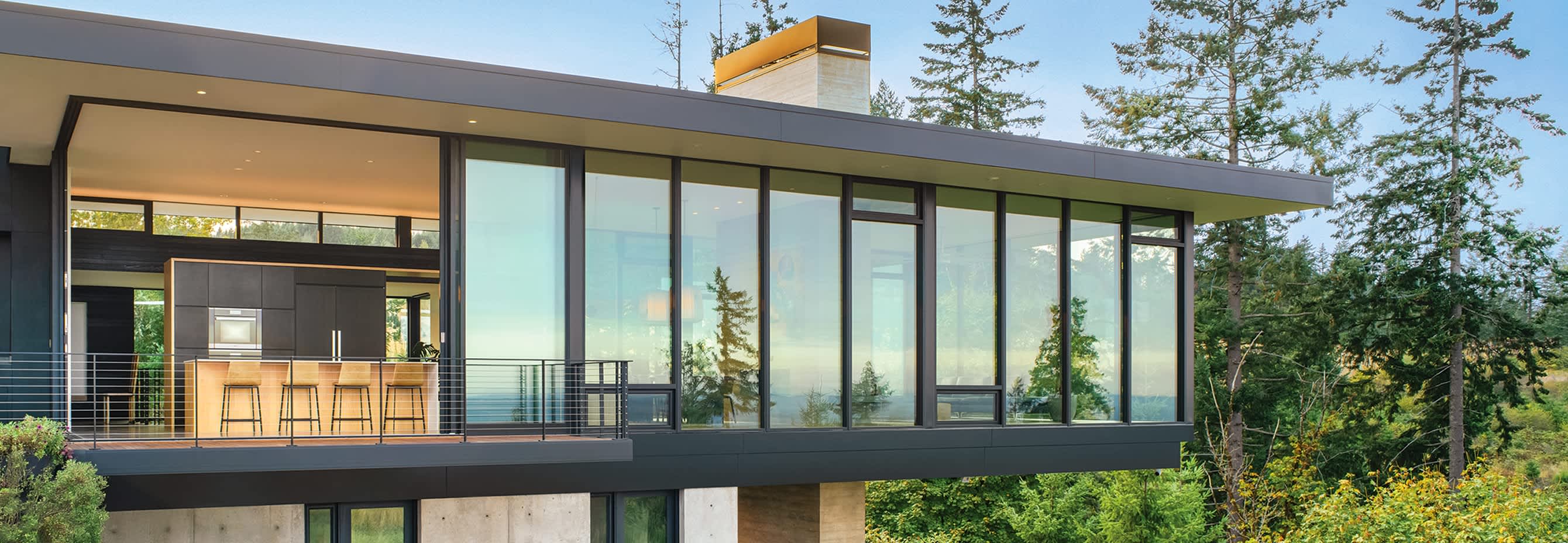 Eckert & Eckert Photography Modern house on a hill side landscape, close up on the large glasswindows