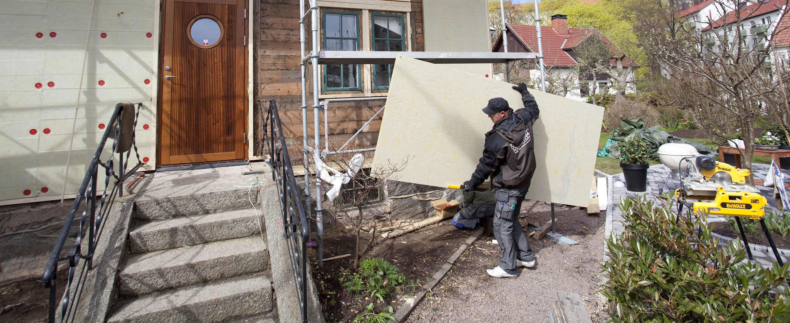 Paroc stone wool insulation being fitted to a building by a male worker