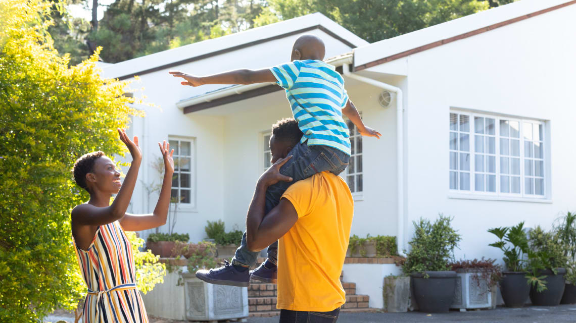 A family playing outside of their home