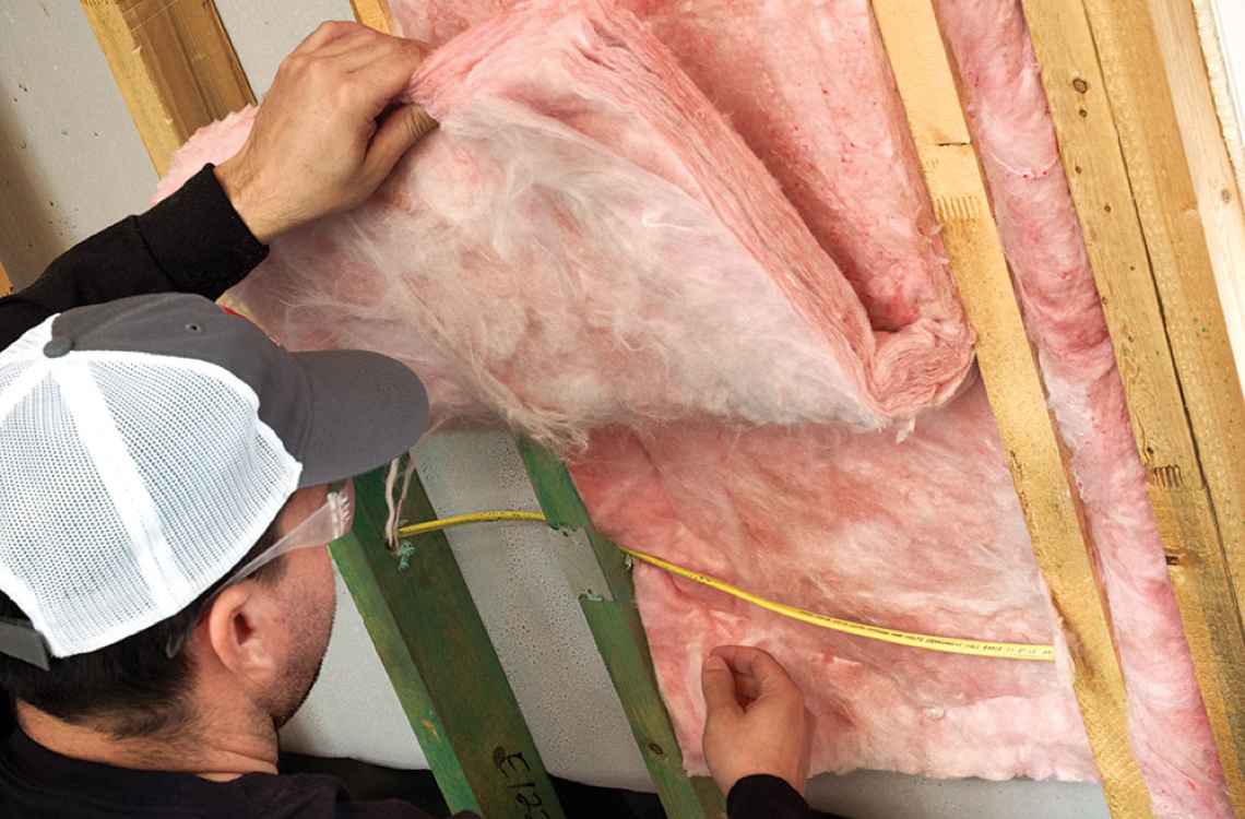 Contractor installing Owens Corning insulation
