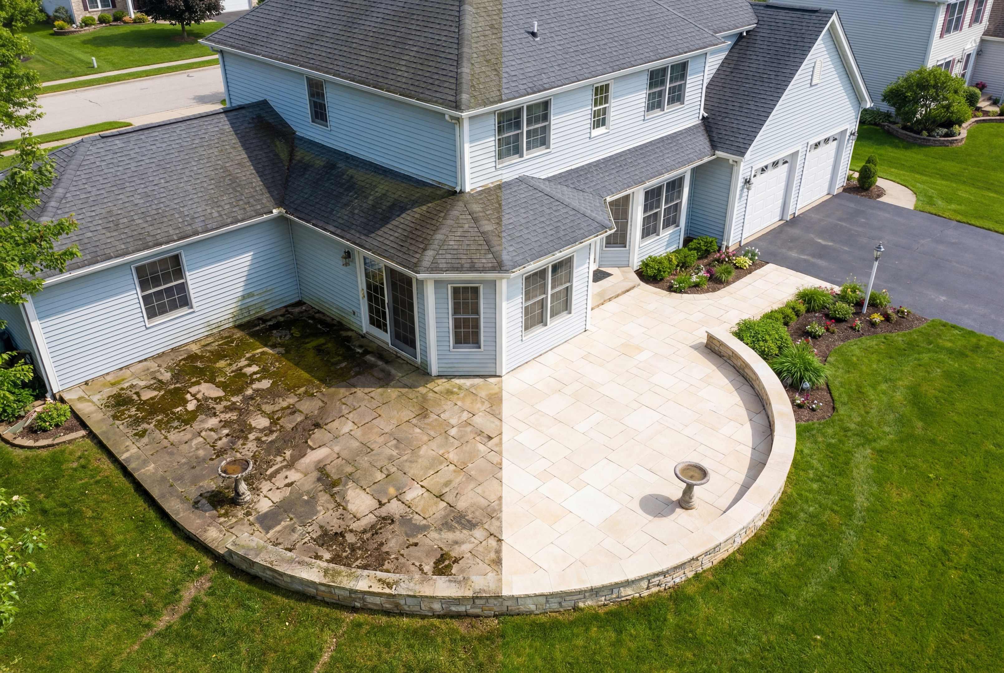 Grey house with grey roofing shingles with half showing "before" and "after" cleaning the roof.