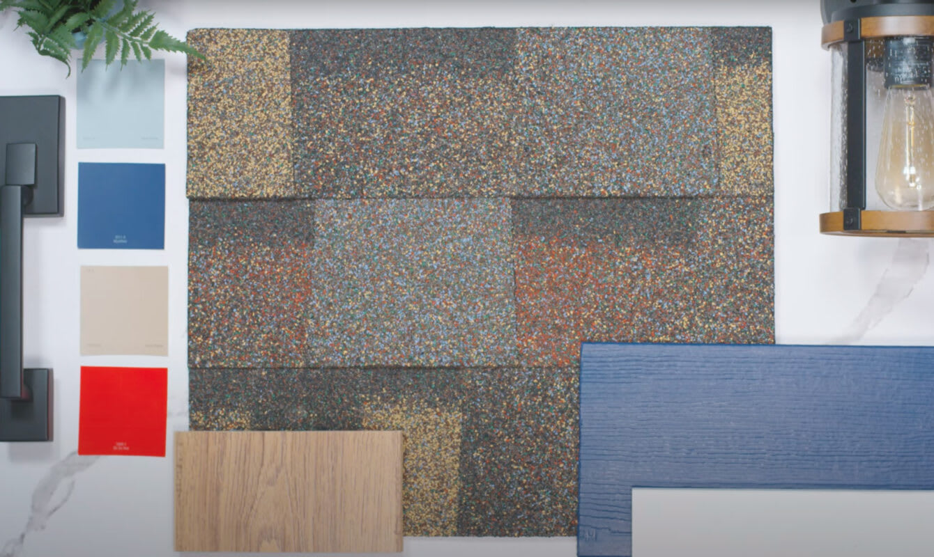 Lay flat view Shingle swatch with paint chip samples in two shades of blue, a black door handle, and a lantern.