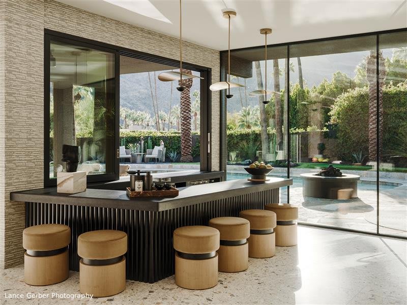 Luxury home bar with brown stools and a Fleetwood sliding passthrough window and EDGE |f| fixed window with narrow site lines. 