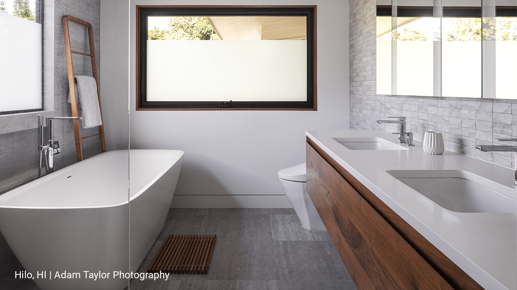 A luxury bathroom with a tub and sink and a partially frosted awning 350-T Fleetwood window.