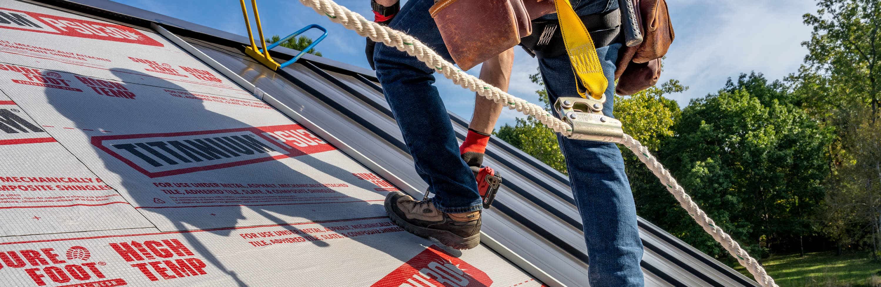 Contractor on a roof deck installing metal roofing over Titanium PSU30