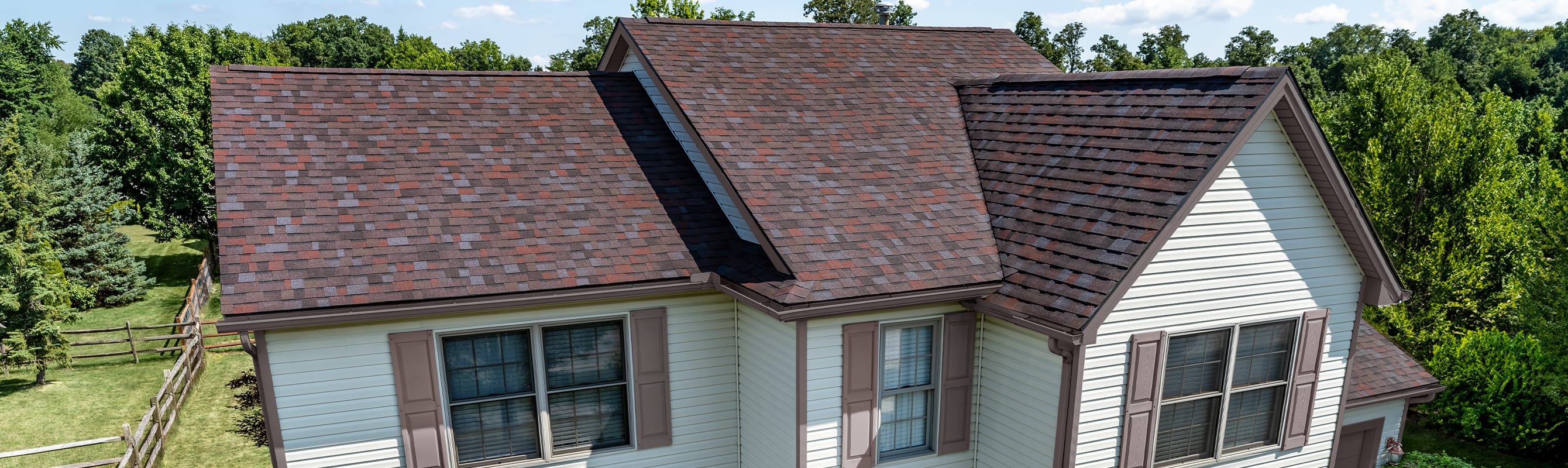Tan home with Owens Corning Duration Designer shingles in Merlot.