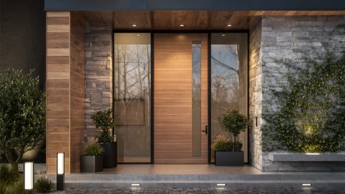 Exterior view of a modern, wood and stone sided porch with a large wooden door with two large windows framing the door.