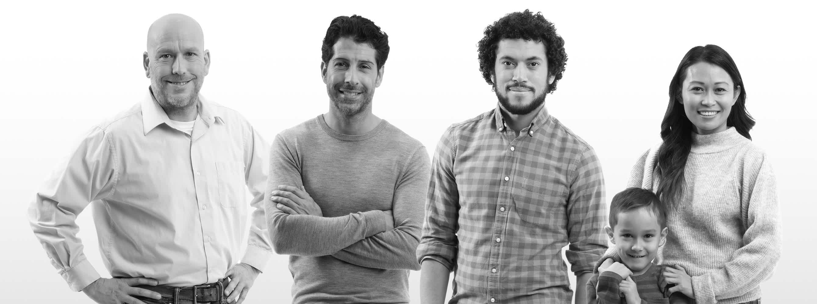Black and white image of distributor, builder, professional installer, and a woman with her son stand in a row, smiling at the camera.
