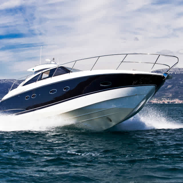 Photo of a motor boat sailing through the water.